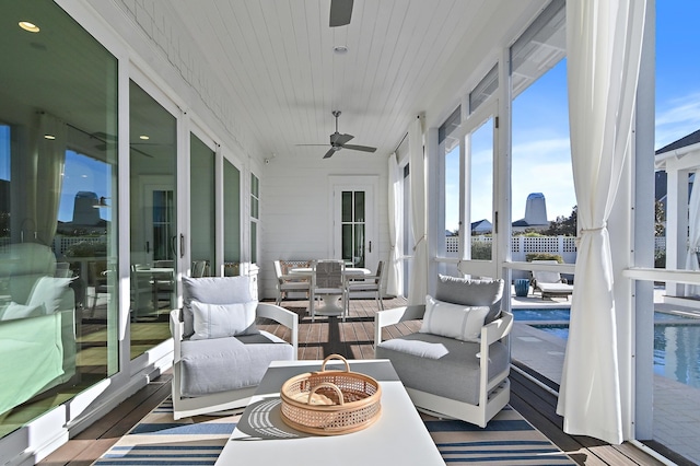 sunroom featuring ceiling fan