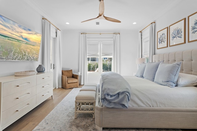 bedroom featuring ceiling fan, crown molding, and light hardwood / wood-style floors