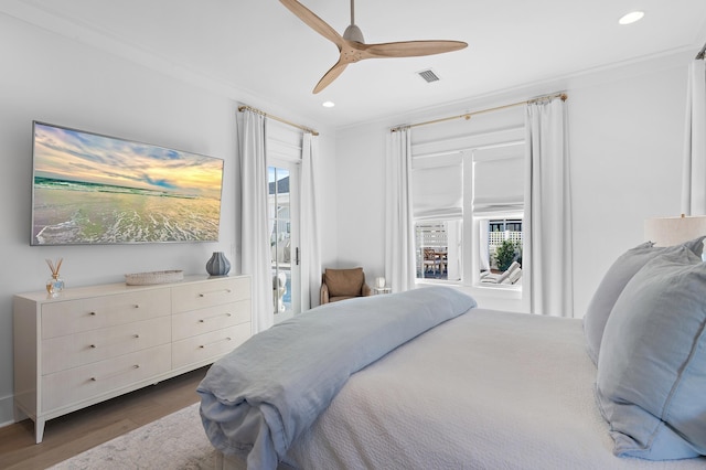 bedroom featuring ceiling fan, dark hardwood / wood-style flooring, and crown molding