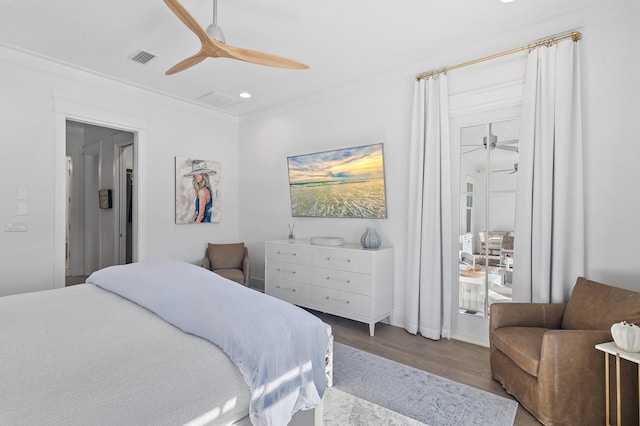 bedroom featuring ceiling fan, ornamental molding, and hardwood / wood-style flooring