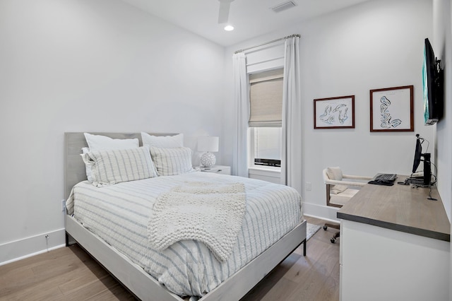 bedroom with hardwood / wood-style floors and ceiling fan