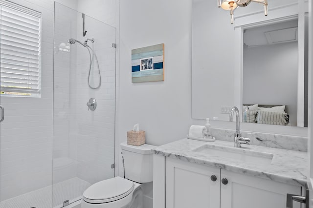 bathroom with vanity, toilet, and a shower with door