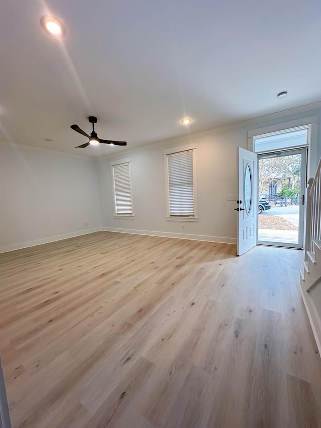 interior space with light hardwood / wood-style flooring, ceiling fan, and ornamental molding