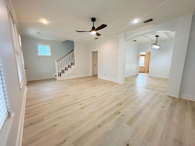 unfurnished living room featuring ceiling fan and light hardwood / wood-style floors