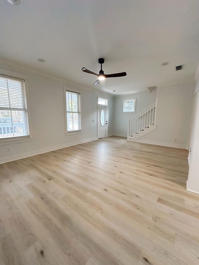 spare room featuring ceiling fan, light hardwood / wood-style floors, and ornamental molding