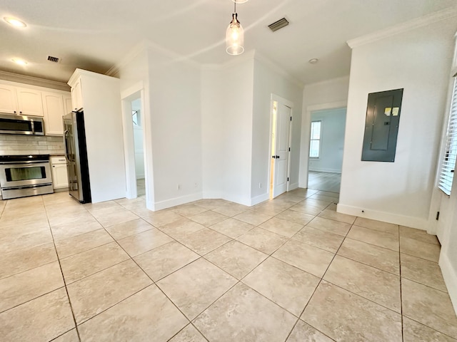 interior space with electric panel, ornamental molding, appliances with stainless steel finishes, tasteful backsplash, and white cabinetry