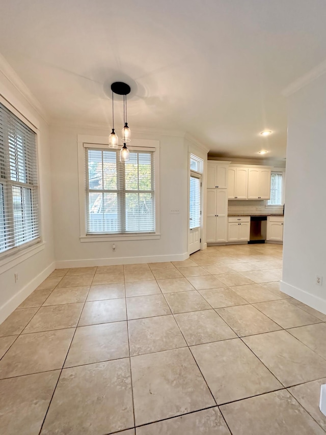 unfurnished dining area with light tile patterned floors and crown molding