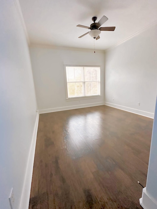 empty room featuring crown molding, ceiling fan, and dark hardwood / wood-style floors