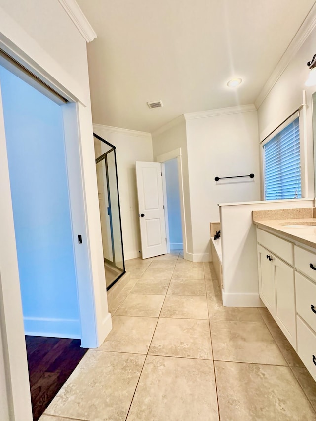 bathroom featuring tile patterned flooring, vanity, shower with separate bathtub, and ornamental molding