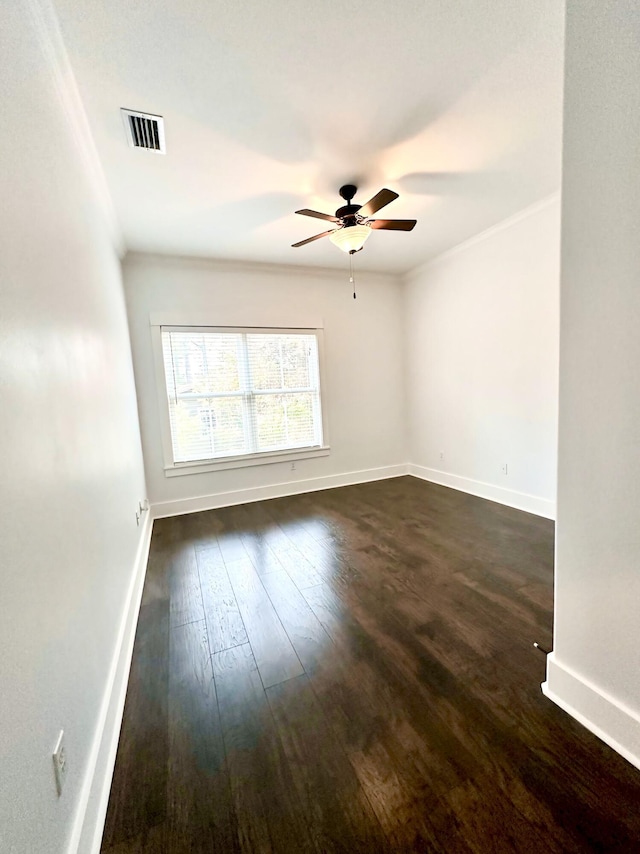 unfurnished room featuring crown molding, ceiling fan, and dark hardwood / wood-style floors