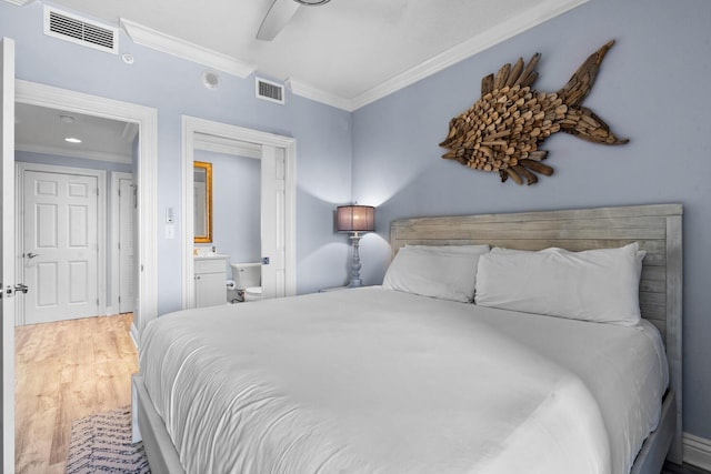 bedroom featuring ceiling fan, wood-type flooring, crown molding, and connected bathroom