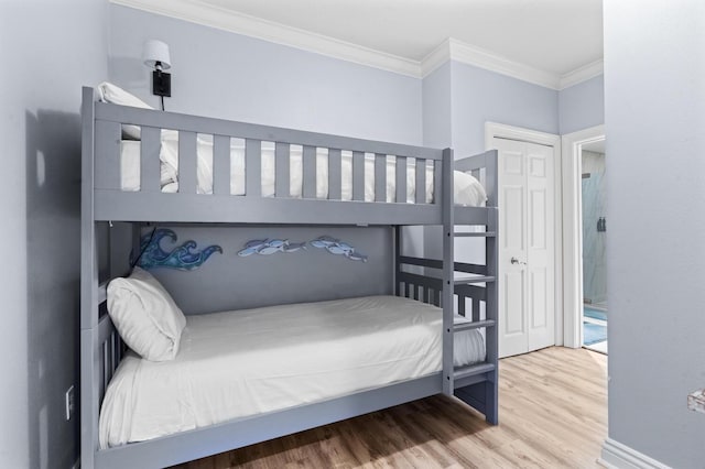 bedroom featuring hardwood / wood-style floors and crown molding