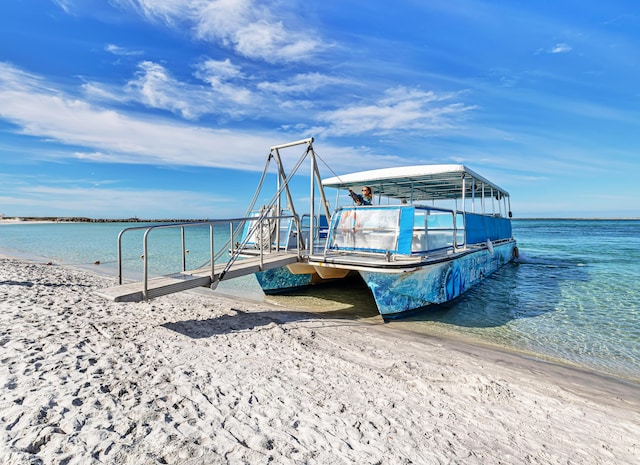 dock area with a beach view and a water view