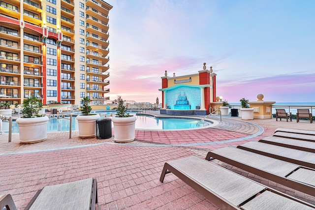 pool at dusk with a water view