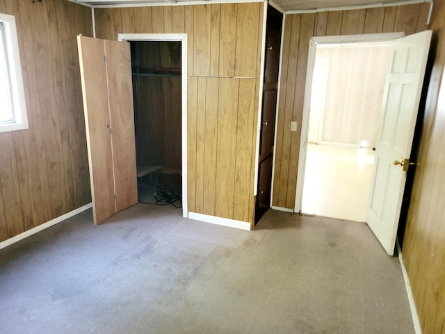 unfurnished bedroom featuring wooden walls and a closet