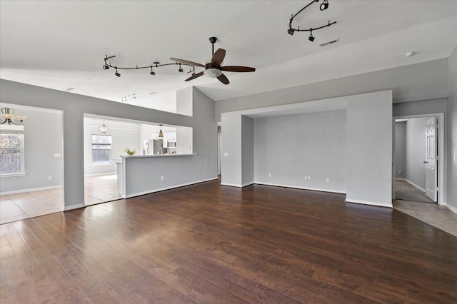 unfurnished living room with ceiling fan, dark hardwood / wood-style flooring, and lofted ceiling