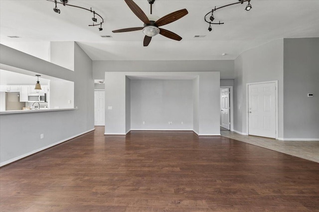 unfurnished living room with ceiling fan, dark hardwood / wood-style flooring, and high vaulted ceiling