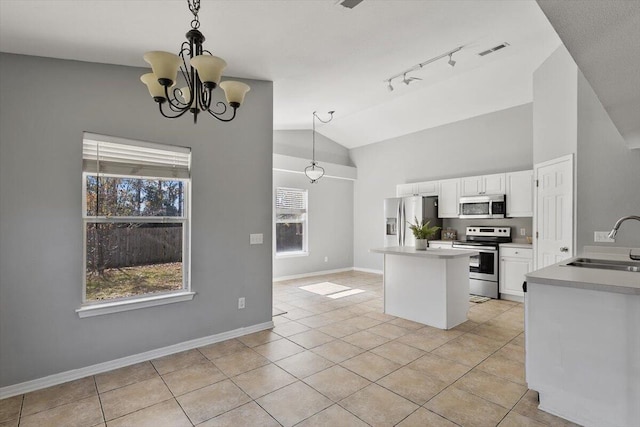 kitchen featuring white cabinetry, sink, hanging light fixtures, an inviting chandelier, and appliances with stainless steel finishes