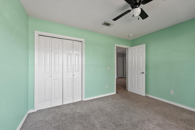 unfurnished bedroom with carpet, a textured ceiling, a closet, and ceiling fan