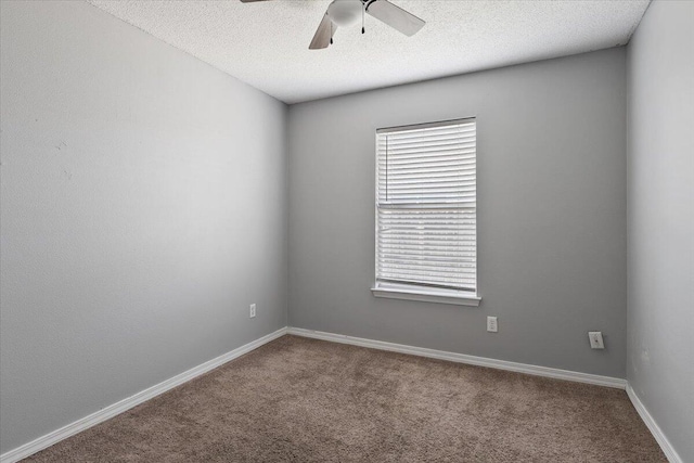 unfurnished room with carpet, ceiling fan, and a textured ceiling