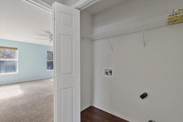 laundry area featuring ceiling fan, dark carpet, a textured ceiling, and washer hookup