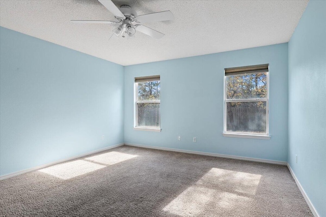 empty room featuring carpet flooring, a textured ceiling, and ceiling fan