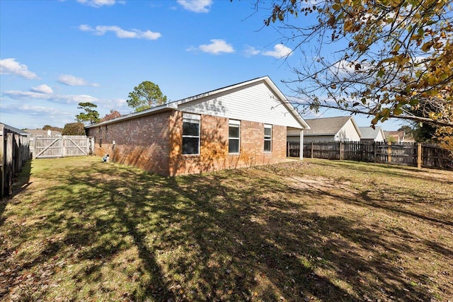 back of property featuring a lawn