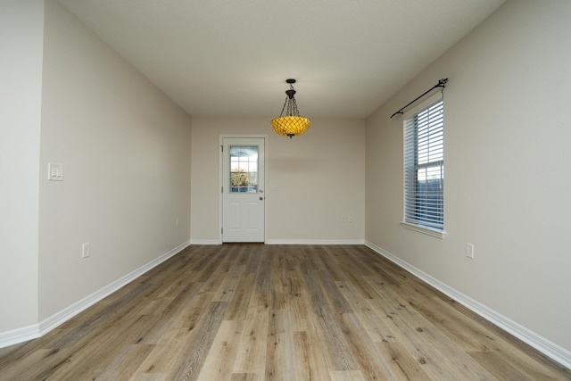 unfurnished dining area with light wood-type flooring and plenty of natural light