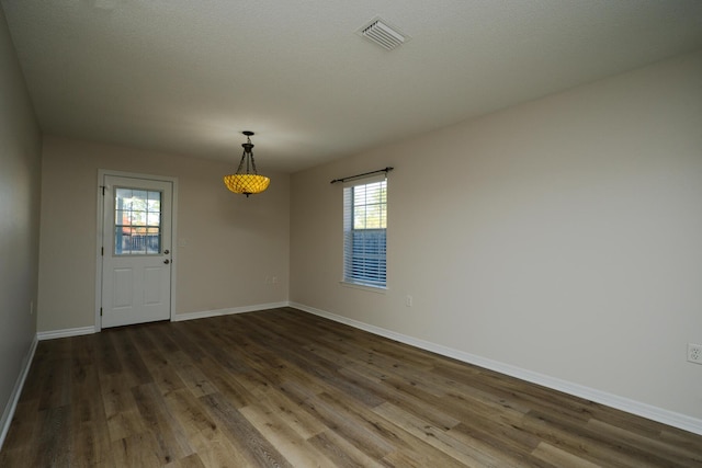 unfurnished room featuring dark hardwood / wood-style flooring