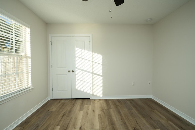 unfurnished room with ceiling fan and wood-type flooring