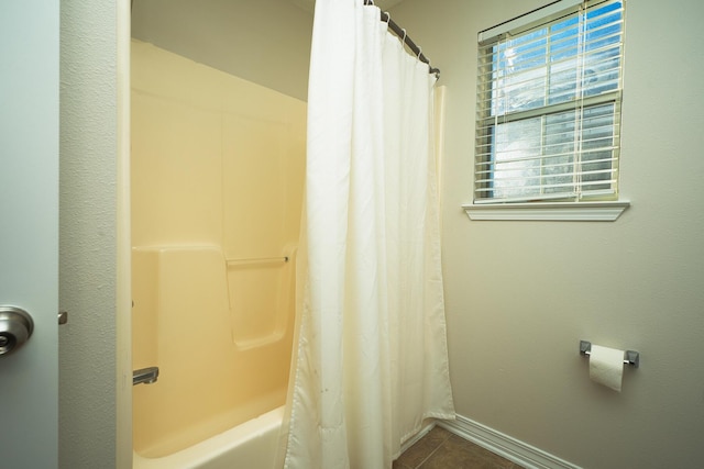 bathroom with tile patterned flooring and shower / bath combo with shower curtain