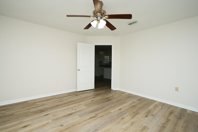 unfurnished room with ceiling fan and light hardwood / wood-style flooring