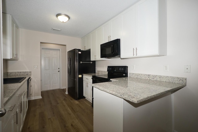 kitchen featuring dark hardwood / wood-style flooring, light stone counters, a textured ceiling, black appliances, and white cabinetry