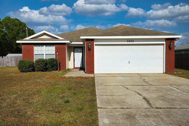 ranch-style home featuring a garage and a front lawn