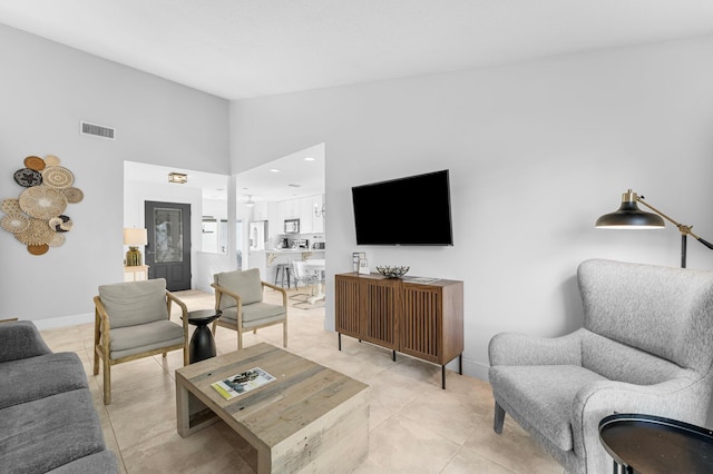 tiled living room with high vaulted ceiling