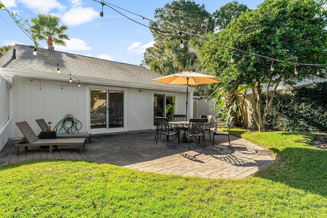 back of property featuring a lawn and a patio area