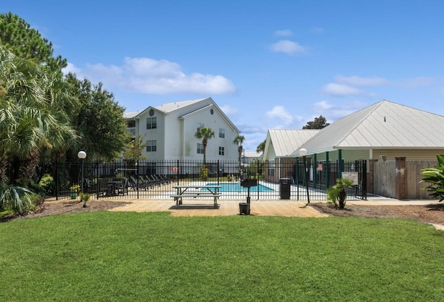 view of pool featuring a yard and a patio