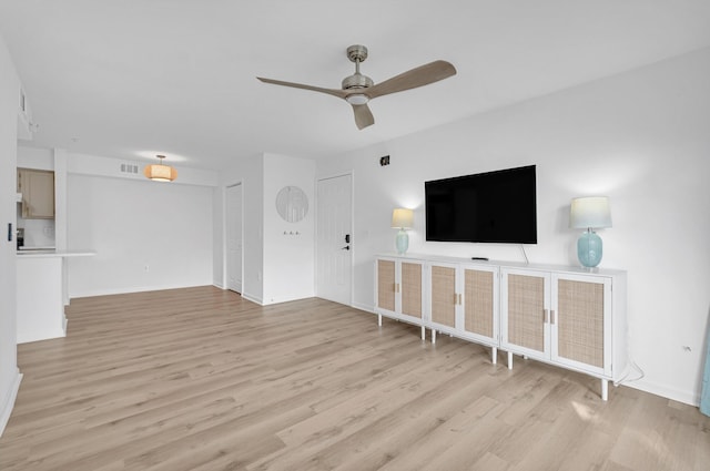 unfurnished living room with ceiling fan and light hardwood / wood-style floors