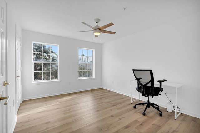 office area with light wood-type flooring and ceiling fan