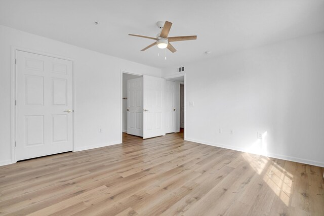 unfurnished bedroom with ceiling fan and light hardwood / wood-style flooring