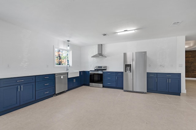 kitchen featuring sink, hanging light fixtures, wall chimney range hood, light tile patterned flooring, and appliances with stainless steel finishes