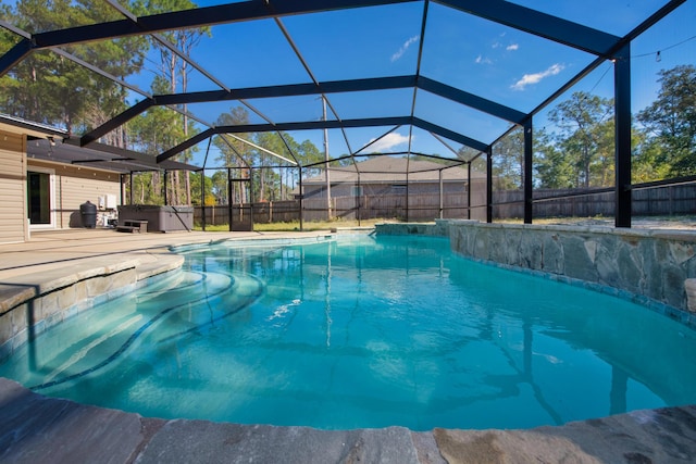 view of swimming pool with a patio and a lanai