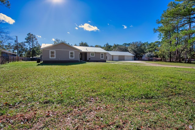 view of front of home with a garage and a front lawn