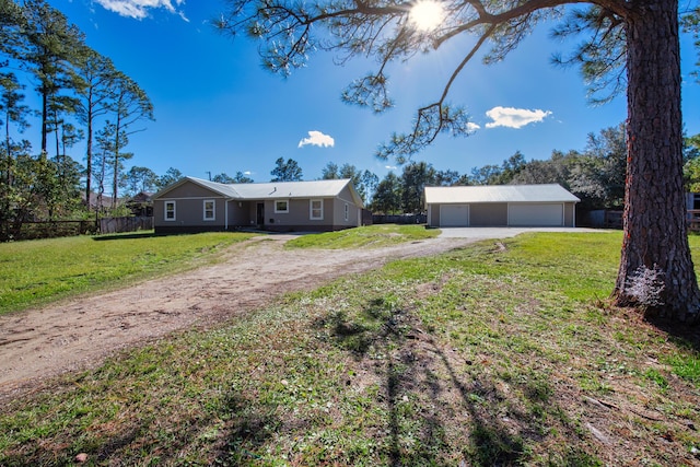 ranch-style house with a front lawn, an outdoor structure, and a garage