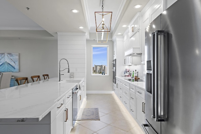 kitchen featuring white cabinets, appliances with stainless steel finishes, pendant lighting, and sink