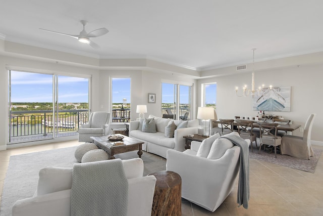 tiled living room featuring ceiling fan with notable chandelier, a water view, and crown molding