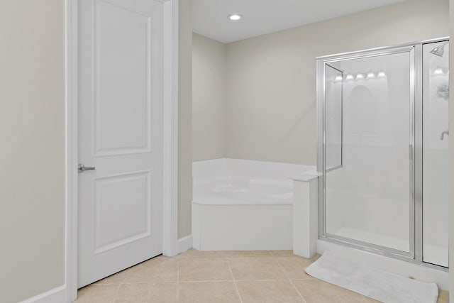 bathroom featuring tile patterned floors and independent shower and bath