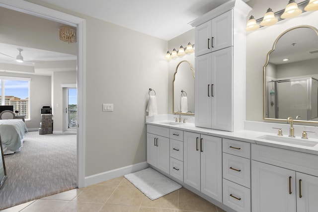 bathroom with ceiling fan, tile patterned flooring, vanity, and an enclosed shower