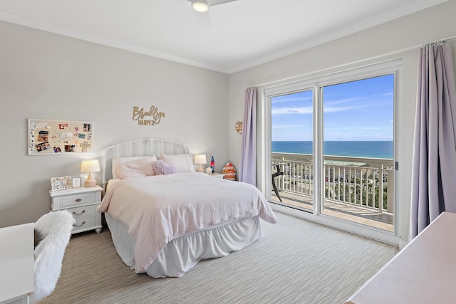 bedroom with access to exterior, a water view, a view of the beach, and ornamental molding