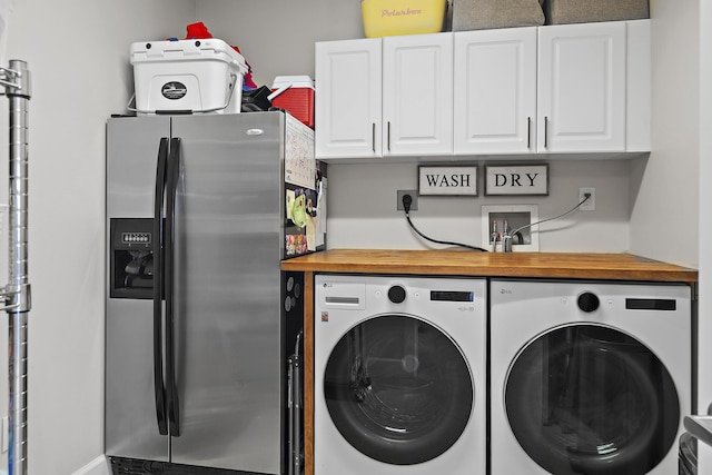 washroom featuring cabinets and separate washer and dryer